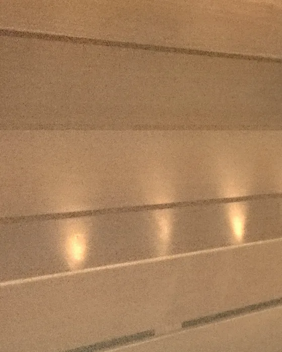 Timber sauna boards lit by a low row of warm lights